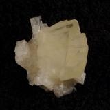 Calcite + chabazite. A nice ’floater’ specimen of transparent yellowish calcite with a matt surface, on lustrous chabazites. Specimen is 23mm high x 20mm x 17mm. Self-collected 2009 from Moonen Bay, Isle of Skye. (Author: Mike Wood)