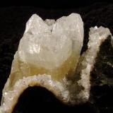 Apophyllite + Chabazite. This is the same specimen as Skye Minerals 091 seen previously, but after trimming, so this view is from the other side. Happily the trimming worked well ! The apophyllite crystal group is 22mm wide and 20mm long, on this side. Self-collected 2004 from Creag na Cuail, Duirinish, Isle of Skye. (Author: Mike Wood)