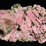 Rhodonite with Franklinite
Franklin, Sussex County, New Jersey  USA
Mined about 1970
Specimen size: 9.3 × 5 × 5.5 cm.
Main crystal size: 2.9 × 0.8 cm.
Former Folch Collection
Photo: Reference Specimens (Author: Jordi Fabre)