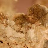 Millerite, acicular with calcite crystals in limestone. Ex Dr. Marvin Rausch. (Author: Gail)