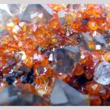 Smokey quartz crystals and spessartine garnets.

Wushan Spessartine Mine, Tongbei, Yunxiao County, Zhangzhou Prefecture, Fujian Province, China. 12 x 10 x 6 cm. (Author: Lumaes)