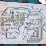 This shows you what a Home-made Printed Circuit board looks like before it is drilled and stuffed with electronic components. These boards are so easy to do it is scary! You start off with a circuit design printed on a clear plastic sheet, place the sheet over a copper board covered with photo resist (Riston) and exposure it to a source of UVA (or sun light), develop and then removed unwanted copper with etchant (ammonium persulphate). The end result is shown in the photo. And the holes are drilled to accept the parts. (Author: Lumaes)