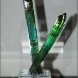A pair of crossed tourmalines from Pederneira Brazil. The largest crystal is 13.5 cm long x 2.0 cm with 2 repairs. The smaller crystal has no repairs. Weight is 90 grams. Sorry about the photo quality (Author: VRigatti)