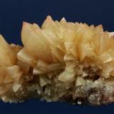 Calcite
Southwest Mine, Warren District, Bisbee, Cochise County, Arizona, USA
83 x 55 x 41 mm

Light orange-brown (hematite-included?), sharp rhombs of Calcite are intergrown and cover this specimen. Some of the crystals have distinct rusty-red tips. This is a classic Calcite from this well-known locality. (Author: GneissWare)