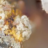 Celestine, Titanite, Pyrite
Poudrette quarry (Demix quarry; Uni-Mix quarry; Desourdy quarry; Carrière Mont Saint-Hilaire), Mont Saint-Hilaire, Rouville RCM, Montérégie, Québec, Canada
FOV=2mm
Celestine is fine mass of white and yellowish crystals and the titanite is the pink crystal masses. (Author: Doug)