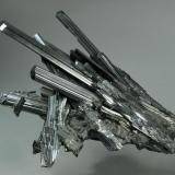Stibnite
Hunan Province, China
205.0 x 125.0 x 121.0 mm
Multiple thick lustrous black crystals of Stibnite to 125 x 17 x 9 mm with a slight bluish cast make up this exceptional 3-dimensional
specimen. Small secondary needles of Stibnite are perched on some of the larger Stibnite crystals. In excellent condition.

Based on the age of the specimen, I suspect this is actually from Wuling Mine, Qingjiang, Wuning Co., Jiujiang Prefecture, Jiangxi Province, China and was labeled Hunan because it was sold in Changsha. (Author: GneissWare)