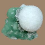 Mesolite
Prospect Park Quarry, Prospect Park, Passaic County, New Jersey, USA
4.8 x 4.4 cm
A 3.3 cm mesolite sphere on prehnite with calcite (Author: Frank Imbriacco)