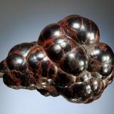 Hematite
Egremont, Cumbria, England
4.1 x 7.2 cm.
A reniform aggregate of reddish-brown "kidney ore." (Author: crosstimber)