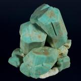 Microcline (v. Amazonite) -- cleaned
Lake George area, Park County, Colorado, USA

130 x 124 x 104 mm

Classic, old-time Colorado Amazonite with sharp, light greenish-blue, blocky crystals of Microcline, on a matrix of white Albite (v. Cleavlandite). The Amazonites are well formed and fully terminated, several of which are well-developed twins. One crystal has a "slot" where it once enclosed a blade of what was likely Cleavlandite. This is an old AE Foote specimen, and was later sold by Filer&rsquo;s (Redlands, CA) and the Bradleys (Los Angeles). Formerly in the Don Boydston and Joel D. Cohen collections. It is complete on all sides, unrepaired and has no damage. (Author: GneissWare)
