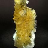 The cubic crystals present geometrical zones of color, some of which have inner oriented inclusions of sulfides, probably Pyrite. A border of white crystals of Calcite partially skirts the specimen.
Moscona Mine (Author: Joan Rosell)