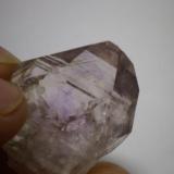 This is the same crystal as the pic above.  You can see the smokey phantom and the purple "
flame" in this pic.  The small mini crystal that is inside this crystal is hard to see due to light refraction but it’s toward the bottom right. (Author: Jason)