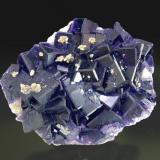 Fluorite with minor Calcite
Tounfit (Tounfite), Boumia, Morocco
Mined in 2006 
Specimen size: 8.1 × 6.8 × 2.6 cm = 3.2” × 2.7” × 1.0”
Main crystal size: 2.1 × 2 cm = 0.8” × 0.8”
Calcite fluorescent long & short UV
Photo: Reference Specimens -> http://www.fabreminerals.com/specimens/SHQ-reference-fine-minerals.php#EH88H6 (Author: Jordi Fabre)
