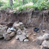 One of the work areas. The larger pocket zone is low on the face, but many smaller, 10 cm. holes are above. The floor of the bench is the bottom of the formation and is barren. (Author: vic rzonca)