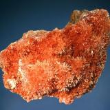 Inesite
N’Chwaning II Mine, Kuruman, N. Cape Prov., South Africa
7.2 x 9.6 cm.
Acicular salmon-colored inesite crystals to 3 mm arranged in radial clusters on a plate of vuggy brown matrix. (Author: crosstimber)