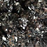 Semseyite
Herja Mine, Baia Mare, Maramures, Romania
5.2 x 6.3 cm. FOV = 1.5 cm.
Numerous platy rosettes of metallic gray semseyite to 4 mm on a matrix of sphalerite and calcite. (Author: crosstimber)