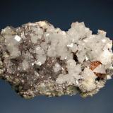 Scheelite
No. 6 Mine, Baia Sprie, Maramures, Romania
2.7 x 4.1 cm.
Unusual sherry-colored scheelite crystal with small calcite rhombs and transparent quartz crystals. Mined in 2001. (Author: crosstimber)