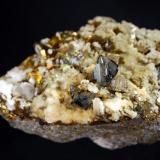 Scheelite
Baia Sprie Mine,
4.1 x 6.3 cm.
Lustrous, smoky-gray, scheelite crystals with small laminar calcite crystals and brassy chalcopyrites. Mined in summer 2002. (Author: crosstimber)