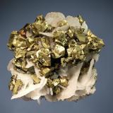 Chalcopyrite
Boldut Mine, Cavnic, Maramures, Romania
6.0 x 6.1 cm.
Ivory-white, wafer-like calcite crystals with brassy, matte-luster chalcopyrite. 
The habit of the calcite is reminiscent of material found in the late 1990s, but this piece was collected in 2005. (Author: crosstimber)