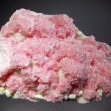 Rhodochrosite
Boldut Mine, Cavnic, Maramures, Romania
7.1 x 9.5 cm.
Bladed pink rosettes with a pearly luster covering quartz/sulfide matrix. Collected in 2003. (Author: crosstimber)