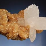 Calcite
Boldut Mine, Cavnic, Maramures, Romania
4.0x 6.0 cm.
Colorless calcites to 4 cm composed of multiple acute scalenohedral crystals set on a matrix of lustrous tan siderite.  Collected in 2001. (Author: crosstimber)