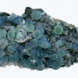 Prehnite
Prospect Park Quarry, Prospect Park, Passaic County, New Jersey, USA
14.2 x 8.8 cm
Blue prehnite spheres to 1.3 cm with calcite, caused by a coating of pumpellyite (Author: Frank Imbriacco)