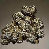Pyrite
Verchniy Mine, Dal’negorsk, Primorskiy Kray, Russia
5.5 x 8.0 cm.
A floater group of brassy pyrite crystals forming rosettes to 1.5 cm. Difficult to photograph because of the high luster and multitude of crystal faces. (Author: crosstimber)