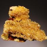 Mimetite
Minerales Shaft, West Camp, Mun. de Aquiles Serdán, Chihuahua, Mexico
6.0 x 7.4 cm.
A limonitic matrix encrusted with mimetite crystals to 5 mm.  The crystals have yellow bases, with an intermediate brown zone, and have mustard yellow pyramidal terminations. (Author: crosstimber)