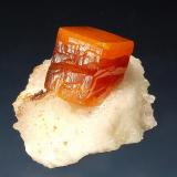 Wulfenite
Erupción Mine, Sierra de Los Lamentos, Chihuauhua, Mexico
2.3 x 2.8 cm.
A bright orange zoned wulfenite crystal on a white calcite matrix. (Author: crosstimber)