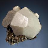 Analcime
Poudrette Quarry, Mont Saint-Hilaire, Monteregie, Quebec, Canada
4.0 x 4.7 cm.
Well-formed dodecahedral crystal of analcime measuring associated with brown siderite and bladed gray albite. (Author: crosstimber)