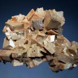 Dolomite
Rabbit Lake Mine, Wollaston Lake, Saskatchewan, Canada
6.5 x 9.0 cm.
An intergrown group of sharp flesh-colored rhombic crystals to 1.7 cm. collected in the early 1980s from the 1240’ bench. (Author: crosstimber)
