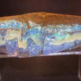 Opal
Queensland, Australia
15 x 6.3 x 5 cm
ex-Bill Rudner.

Way back when, a person could stop by Chris Wright’s place in Hot Springs and go through a bin with boulder opal rough.  It was sold by the pound.  That was okay because about 99.99% of it was ironstone matrix.  I suspect that  possibly as many as a dozen people have high-graded it before it got to the bin but every now and again Chris would put back a piece for that special person.  Unfortunately, more often than not, I was usually not that person. (Author: Don Lum)