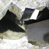 Pyrite
Ampliación a Victoria Mine, Navajún, La Rioja, Spain
9 x 9 x 7 cm.
Detailed of previous specimen. Three grouped pyrite crystals in matrix. It has a very brilliant and smooth faces similar to a mirror. Crystals size 2 cm. (Author: supertxango)