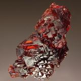 Spessartine
Navegadora Mine, Penha do Norte, Minas Gerais, Brazil
2.5 x 4.5 cm.
Gemmy burgundy-red crystal exhibiting striations and stepped growth features. (Author: crosstimber)