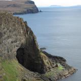 &rsquo;Glen Caladale&rsquo;, Loch Eynort, Isle of Skye, Scotland, UK
The stilbite locality (and the laumontite locality) is in the huge boulders on the wave-cut platform to the right of the big cave - which is approx. 25m high ! The beach to the left of the cave is surprisingly devoid of minerals.
 In the distance (looking south) can be seen the distinctive sea-stack (named Stac an Tuill) at the north end of Sgurr nam Boc / Sgurr an Duine localities.
Photo taken April 2010 (Author: Mike Wood)