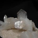 Stilbite
Sgurr nam Boc, Isle of Skye, Scotland, UK
FOV 5cm x 4cm approx.
Simple thin stilbite crystals to 10mm arranged on a thin layer of tiny pink heulandites, on basalt matrix.
Self-collected 1994 (Author: Mike Wood)