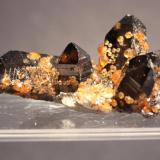 Spessartine, Quartz (var Smoky Quartz)
Wuhan Spessartine Mine,Tongbei, Fujian Province, China
6.2 x 4.5 cm
Spessartine Garnet on and included in Smoky Quartz (Author: Don Lum)