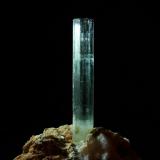 Beryl (var aquamarine)
Lundy Island, Devon, England, UK
27mm x 4mm crystal
Undamaged terminated crystal on quartz/feldspar pegmatitic matrix - repaired at the base ! (After getting it home in one piece)   -_- (Author: Mike Wood)