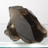 Smoky Quartz
Isle of Arran, Scotland, UK
65mm x 45mm x 45mm
Same specimen as above. The large, smooth crystal face is nearly 5cm long. (Author: Mike Wood)