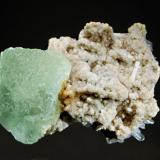 Fluorite
Huanzala Mine, Huallanca District, Dos de Mayo Province, Huanuco Dept., Peru
5.5 x 7.0 cm.
Pale green octahedral fluorite crystal measuring 4.0 cm on a matrix of cream to tan dolomite and quartz crystals. (Author: crosstimber)