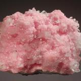 Rhodochrosite
Santa Rita Mine, Morococha District, Yauli Province, Junín Department, Peru
5.0 x 7.0 cm.
A druse of lustrous pink hodochrosite crystals interspersed with transparent quartz crystals on a massive rhodochrosite and sulfide matrix. (Author: crosstimber)