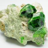 Andradite (var: Demantoid)
Belqeys Mountain (Kuh-e-Belgheys), Takab, West Azarbaijan Province, Iran
Larger crystal is 1.6 cm. The specimen is 5 cm in length.
A gorgeous and impressive specimen of lustrous bright/dark green demantoid garnet from a new find. (Author: vhairap)