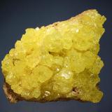 Sulfur
El Desierto Mine, San Pablo de Napa, Daniel Campos Prov., Potosi Dept., Bolivia
6.4 x 8.4 cm.
Gemmy, complex sulfur crystals on a gray altered volcanic matrix. (Author: crosstimber)