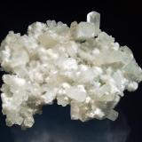 Apophyllite-(KF)
Kandivali Quarry, Malad, Ward 38, Mumbai District, Maharashtra, India
7.5 x 9.5 cm.
Colorless elongated pseudocubic crystals of apophyllite on pale green prehnite associated with snow white spheres of acicular okenite. (Author: crosstimber)