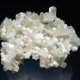 Apophyllite-(KF)
Kandivali Quarry, Malad, Ward 38, Mumbai District, Maharashtra, India
7.5 x 9.5 cm.
Colorless elongated pseudocubic crystals of apophyllite on pale green prehnite associated with snow white spheres of acicular okenite. (Author: crosstimber)