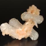 Stilbite-(Ca)
Chalsigaon, Jalgaon District, Maharashtra, India
6.6 x 6.8 cm.
Bladed, colorless stilbite crystals to 4.0 cm on a stalactite of small peach-colored heulandite crystals. (Author: crosstimber)