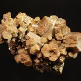 Vanadinite var. arsenian
Zelidja Mine, Touissit, Oujda-Angad Province, Oriental Region, Morocco
4.5 x 7.5 cm.
Barrel-shaped vanadinite crystals with slightly hoppered pinacoid terminations. (Author: crosstimber)