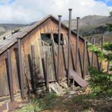 A steam manifold at the rear of the winch house feeds the dual cylinders that power the winch. The view is toward the east and Mosquito Pass. The divide follows the ridge line, there is rain over there. (Author: vic rzonca)