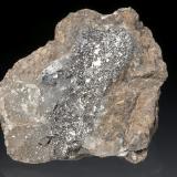 Sylvanite, Nagyagite
Baia de Arie&#351; (Offenbánya), Alba Co., Romania
5,5x5x2,5 cm
Very rich and interesting specimen due to the rare association for the locale. Nagyagite is visible in minor lead gray leafs on the middle left. (Author: Simone Citon)