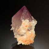 Quartz var. amethyst
Tonglushan Mine, Daye Co., Huangshi Pref., Hubei Prov., China
3.3 x 4.8 cm
A single amethyst crystal with a partial jacket of small scalenohedral calcite crystals with reddish-brown tinged terminations. (Author: crosstimber)