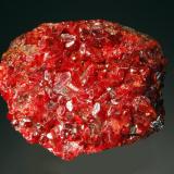 Realgar
Jiepaiyu Mine, Shimen, Changde Pref,, Hunan Prov., China
6.5 x 7.8 cm
Bright red realgar crystals covering the top surface of massive realgar. Obtained from Peter Wu at the 1990 Denver Show. (Author: crosstimber)